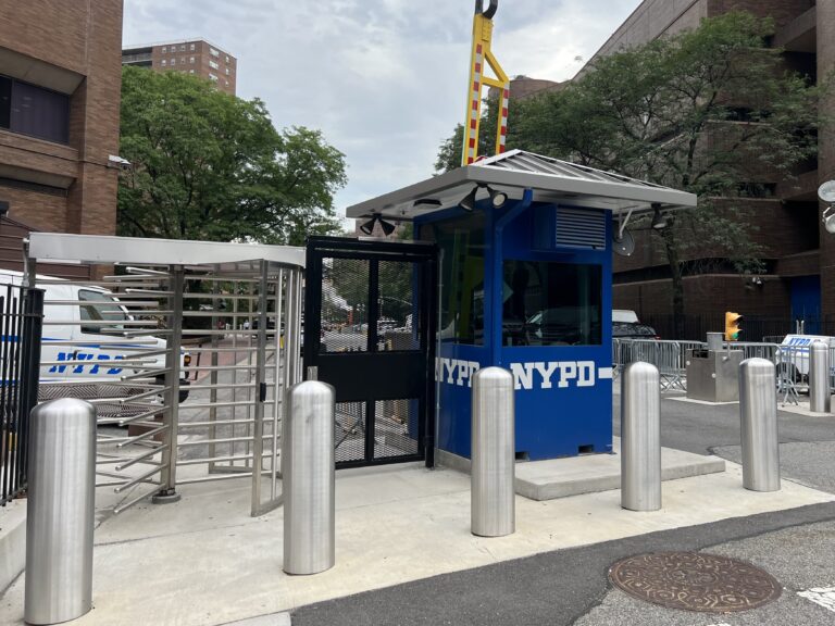 bollards with silver covers in front of a guard station