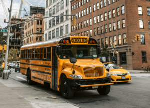 hoto of school bus parked on New York City street to accompany blog about enhancing campus safety.