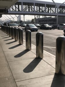 Row of black bollards on a sidewalk