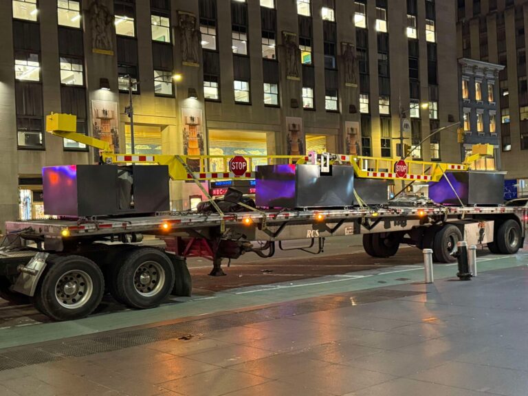 Flexible perimeter security - Photo of drop arm barriers on a flatbed truck on a NYC street.