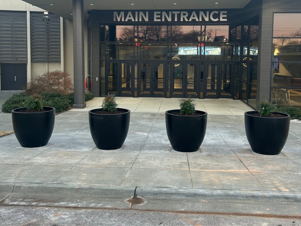 Planter bollards in front of a church building. Protecting public spaces.