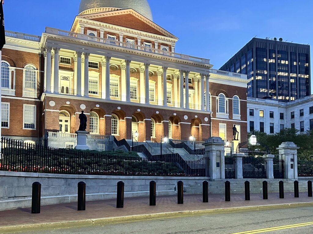 Bollards in front of a government building at night. Protecting public spaces.