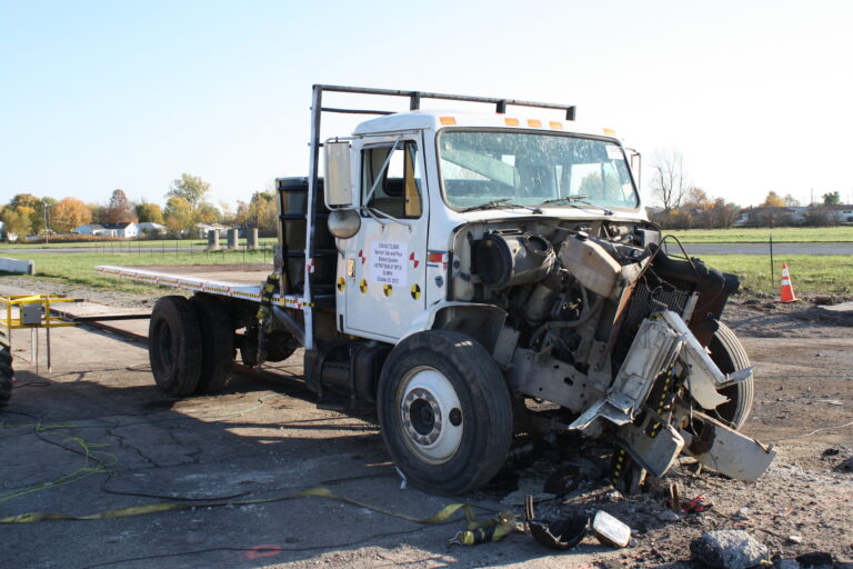 Photo of a truck with the front end destroyed from crashing into a Hercules M30 bollard during a crash test.