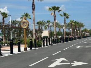 row of Hercules M30 bollards lining the road at an amusement park entrance.