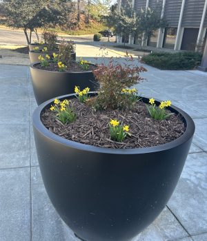Planter bollard cover with flowers.
