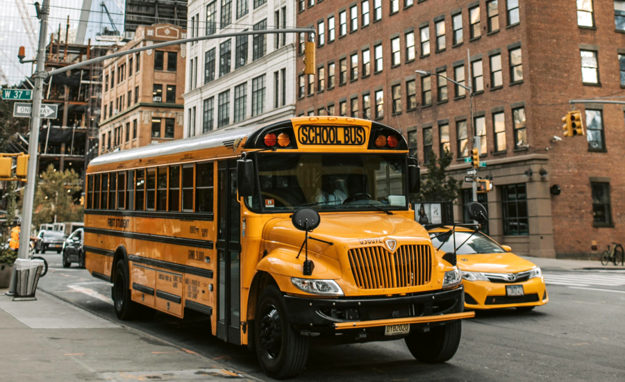 hoto of school bus parked on New York City street to accompany blog about enhancing campus safety.